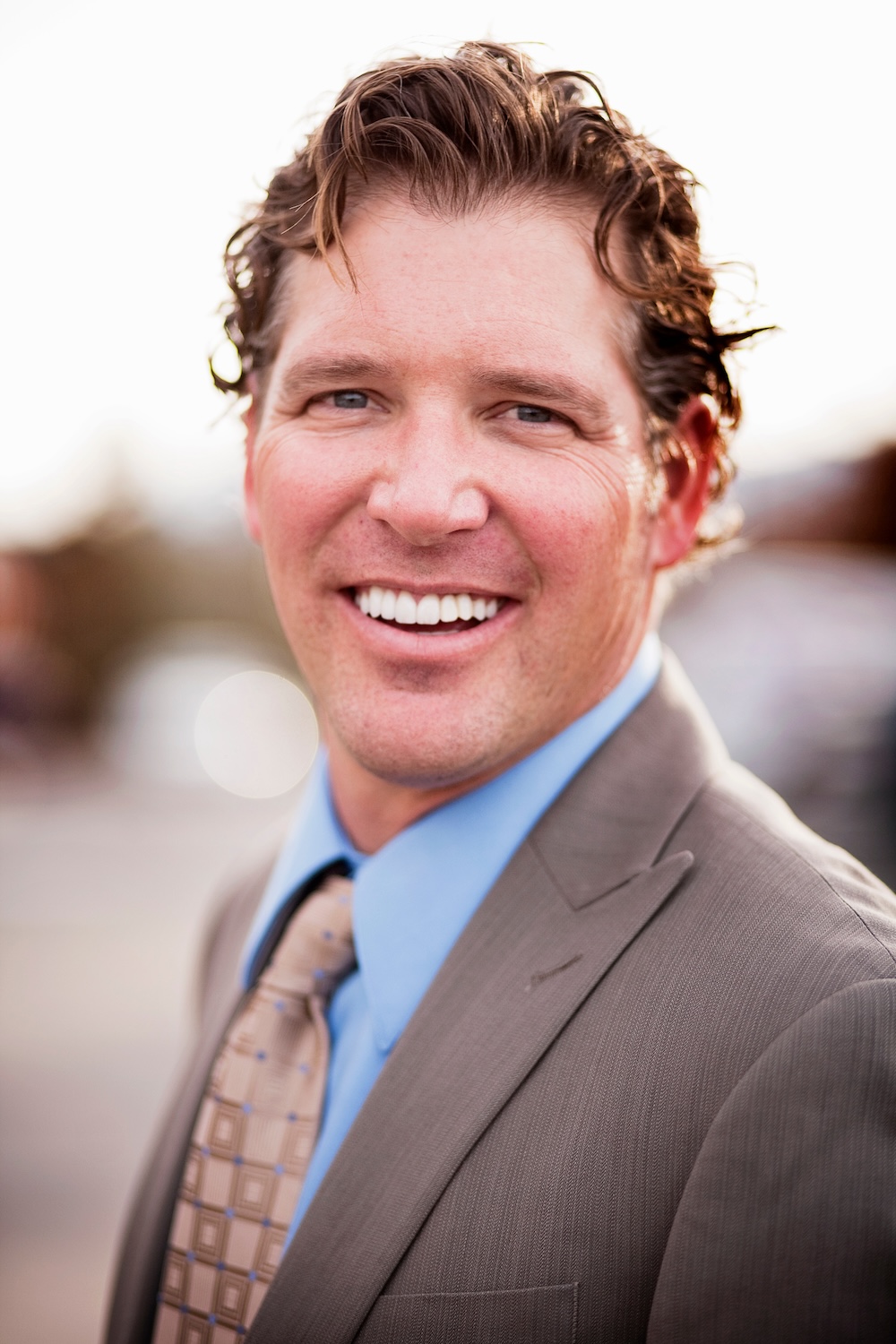 Portrait of smiling man in suit First Last